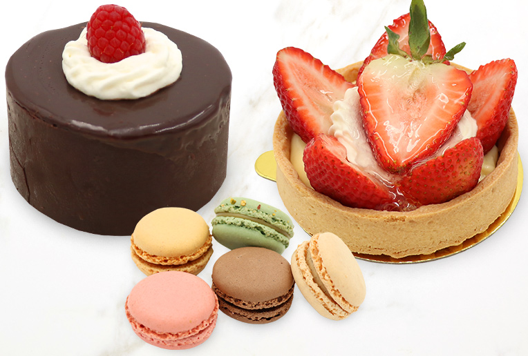 Chocolate Cake, Tart and macarons on Marble Surface